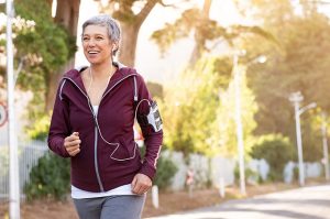 a senior woman going for a jog to represent the importance of exercise in the post menopausal years