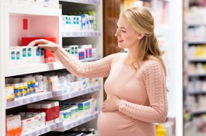 a pregnant woman shopping for prenatal vitamins