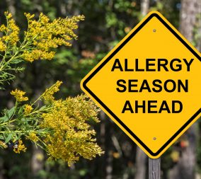 A Caution sign that says Allergy Season Ahead