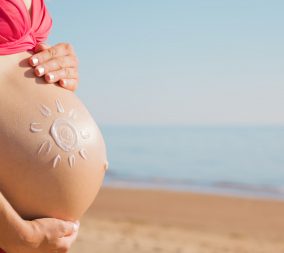 a woman on the beach with a summer pregnancy