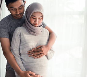 A young woman in her second trimester with her partner