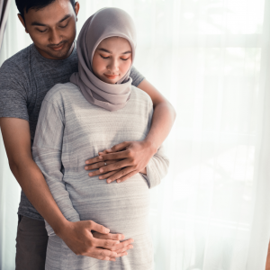 A young woman in her second trimester with her partner