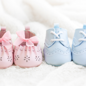 Baby shoes in pink and blue to represent the idea of morning sickness and gender