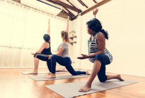 three pregnant women doing yoga to show the importance of exercise in pregnancy