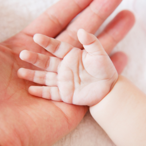 a mother and newborn baby's hands to represent vaginal seding