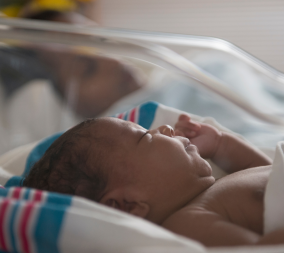A new born baby to represent the questions about delayed cord clamping