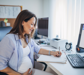 A pregnant woman doing research on a laptop to figure out if she should eat her placenta