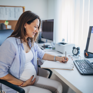 A pregnant woman doing research on a laptop to figure out if she should eat her placenta