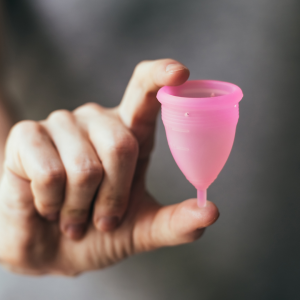 A woman holding a menstrual cup