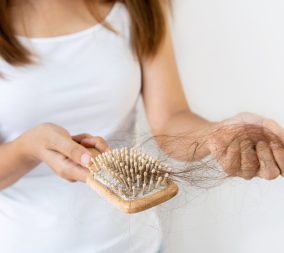 a woman dealing with postpartum hair loss