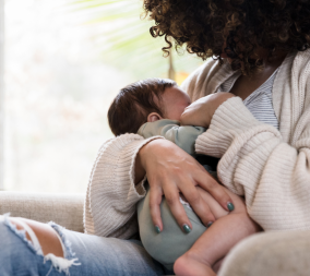 A mom breastfeeding to represent the maternal benefits of breastfeeding