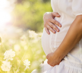 A pregnant woman outside to represent the weather and your pregnancy